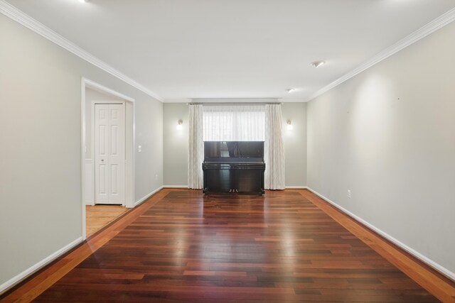 unfurnished living room with baseboards, ornamental molding, and wood finished floors