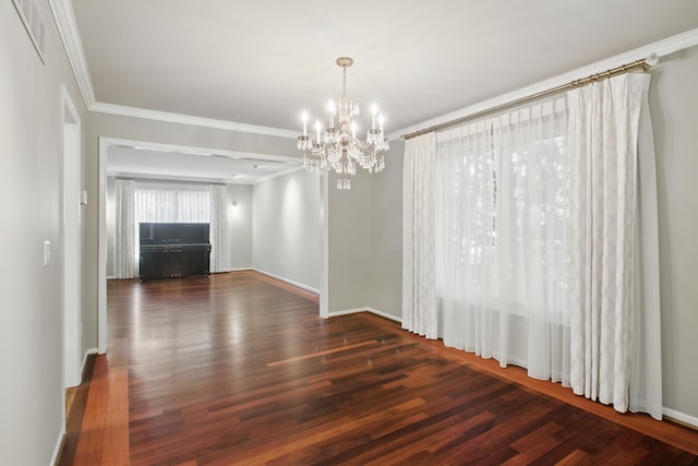 unfurnished dining area with visible vents, ornamental molding, wood finished floors, baseboards, and a notable chandelier