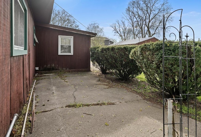 view of side of property with a patio and fence