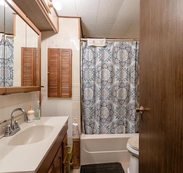 full bathroom with toilet, shower / bath combination with curtain, and vanity