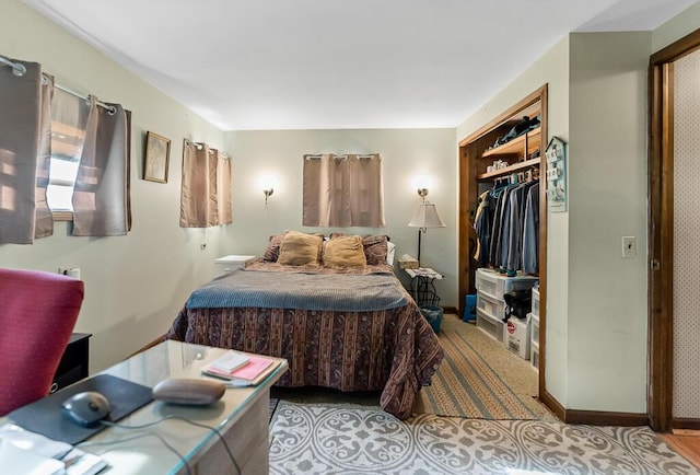 bedroom featuring baseboards and a closet