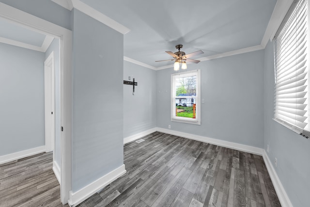 empty room with ceiling fan, baseboards, and wood finished floors