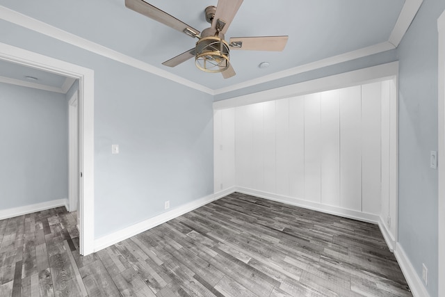 unfurnished room with ceiling fan, crown molding, baseboards, and wood finished floors