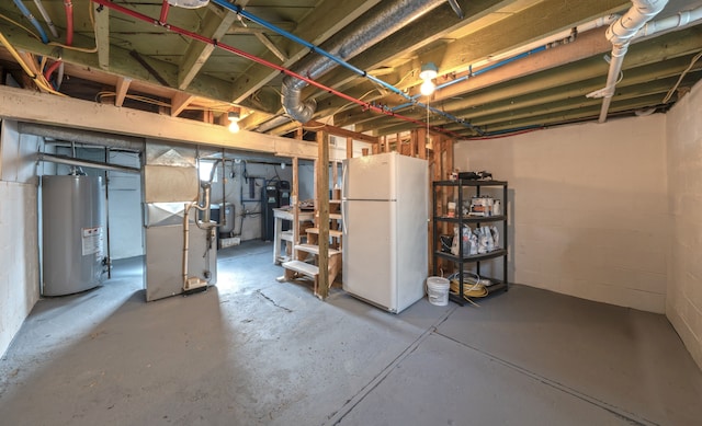 unfinished below grade area with freestanding refrigerator, heating unit, and water heater
