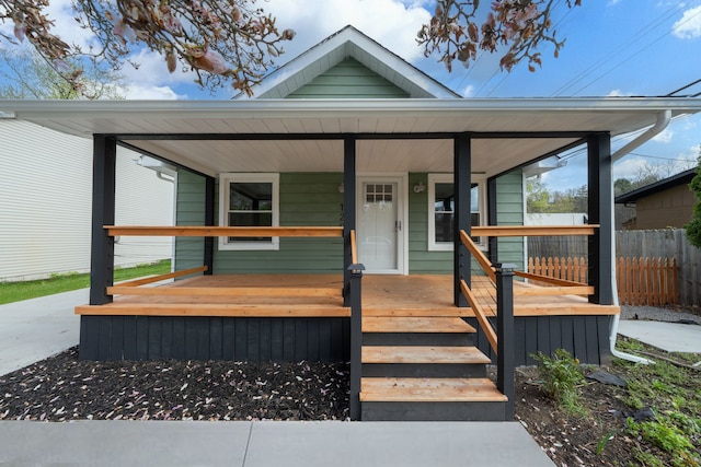 view of front of house with a porch and fence
