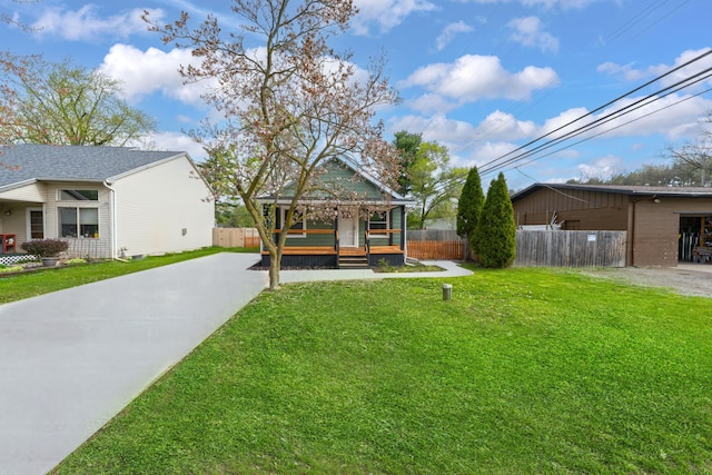 view of yard featuring fence and driveway