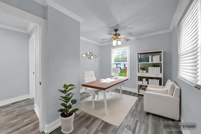 office space with baseboards, ceiling fan, crown molding, and wood finished floors