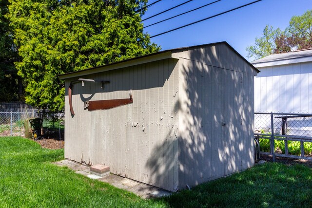 view of shed featuring fence
