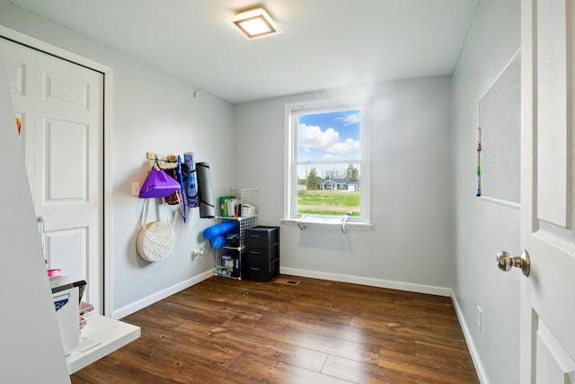 bedroom featuring baseboards and dark wood finished floors