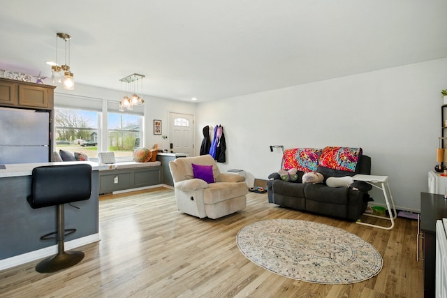 7330 Charlotte Rd, Lexington, MI 48450 - living room with a chandelier and light wood-type flooring