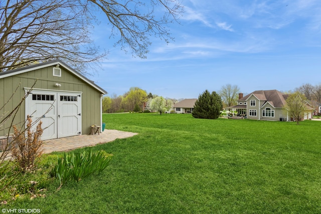 view of yard featuring a storage unit and an outbuilding