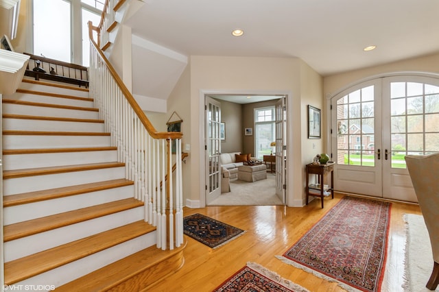 foyer entrance featuring stairway, french doors, recessed lighting, and wood finished floors