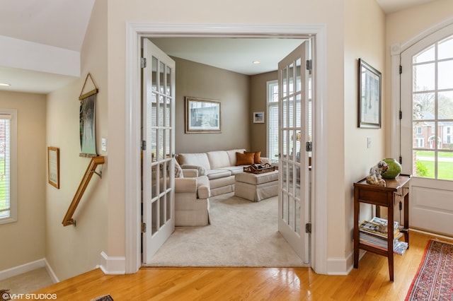 interior space with french doors, baseboards, and wood finished floors
