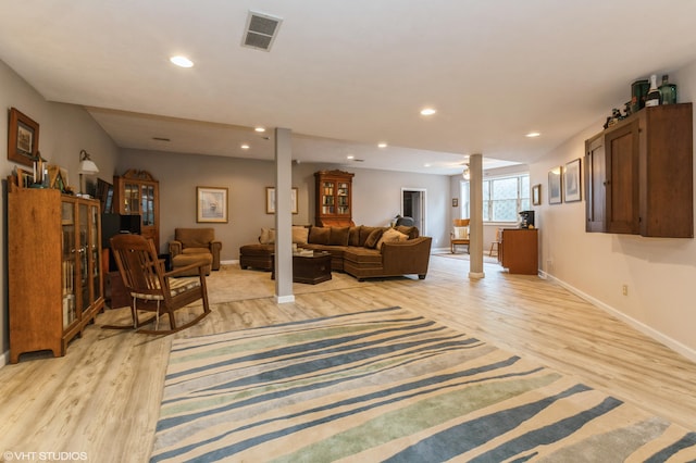 living area featuring visible vents, baseboards, and light wood-type flooring