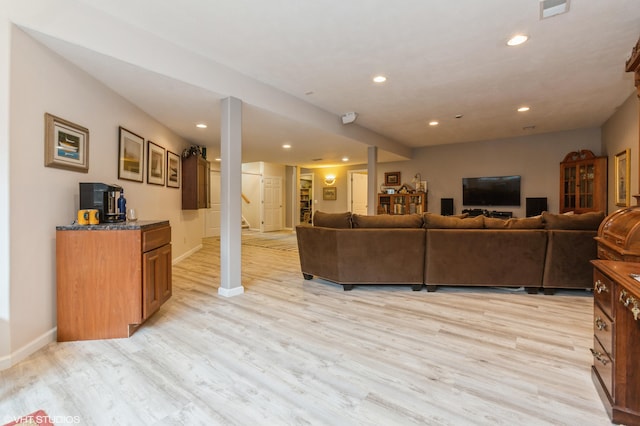 living area featuring recessed lighting, baseboards, and light wood finished floors
