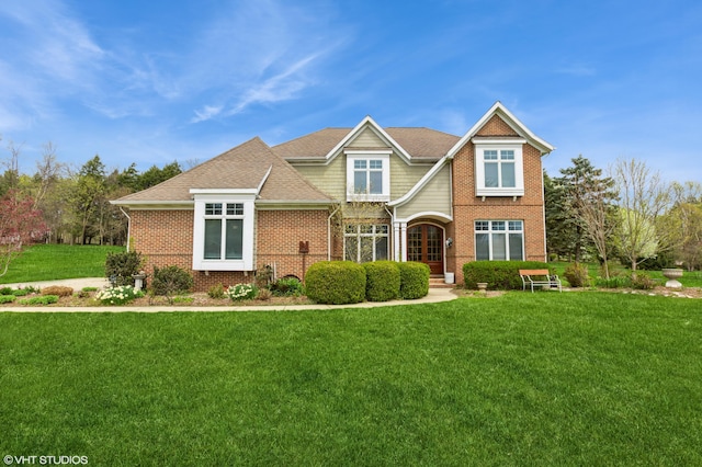view of front of home featuring brick siding and a front lawn