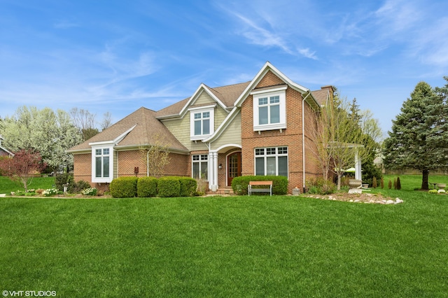 craftsman-style house with brick siding and a front yard