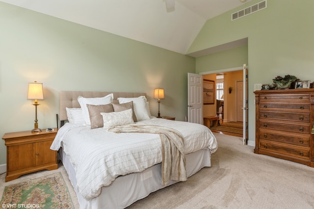 bedroom with ceiling fan, visible vents, baseboards, lofted ceiling, and light carpet