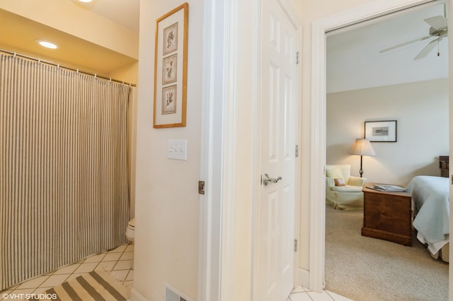 bathroom featuring toilet, ceiling fan, visible vents, and tile patterned flooring