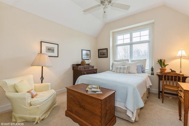 bedroom featuring baseboards, ceiling fan, light carpet, and vaulted ceiling