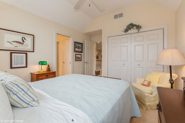 carpeted bedroom featuring visible vents, a ceiling fan, vaulted ceiling, and a closet
