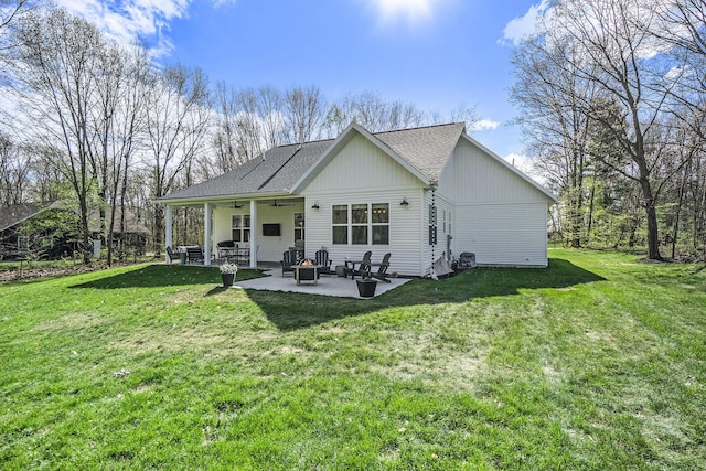 1709 Westview Dr, Allegan, MI 49010 - rear view of property with a patio, a ceiling fan, a yard, and a shingled roof