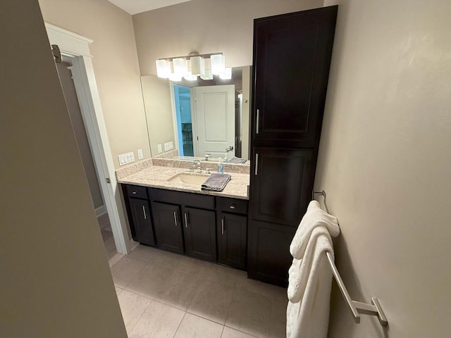 bathroom featuring tile patterned flooring and vanity