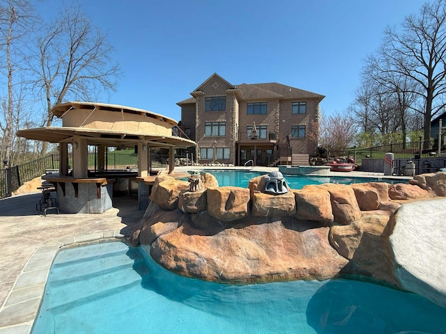 view of swimming pool featuring fence, outdoor dry bar, a gazebo, a jacuzzi, and a fenced in pool