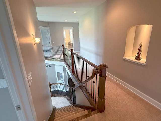 stairway featuring carpet floors, recessed lighting, baseboards, and visible vents