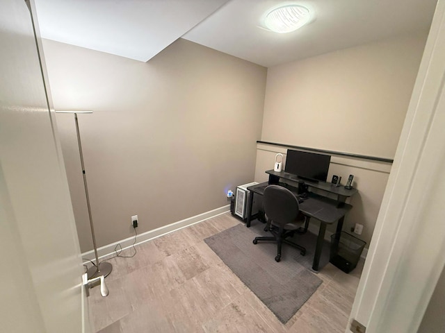 office space featuring baseboards and wood finished floors