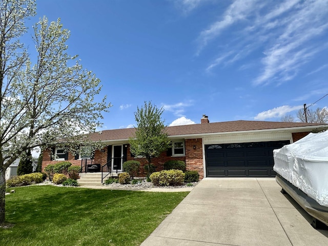 ranch-style house featuring a chimney, brick siding, a front lawn, concrete driveway, and an attached garage