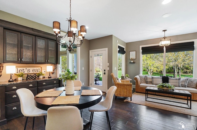 dining area with dark wood-style flooring, a chandelier, plenty of natural light, and recessed lighting
