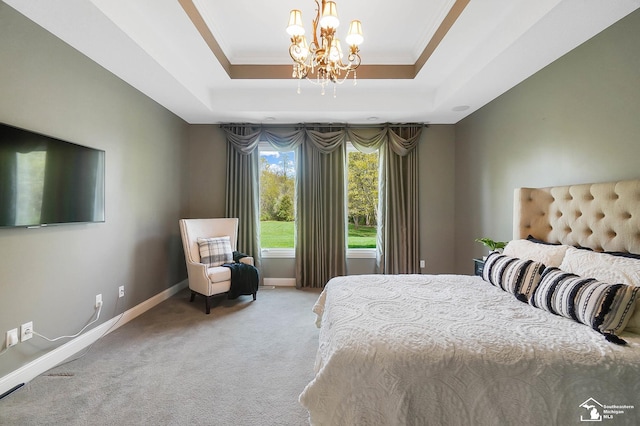 bedroom with a tray ceiling, baseboards, light colored carpet, and a chandelier