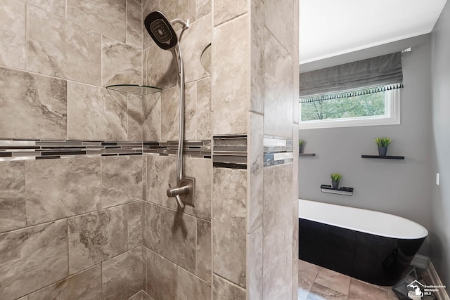 bathroom with a freestanding tub and a tile shower