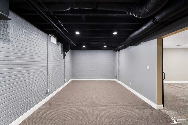 finished below grade area featuring baseboards and carpet