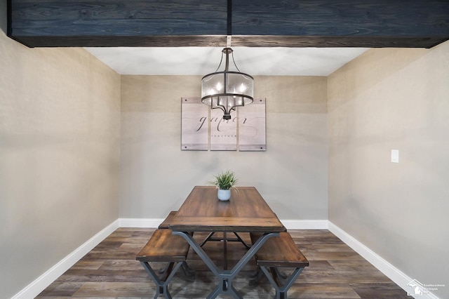 dining room featuring baseboards, wood finished floors, and a chandelier