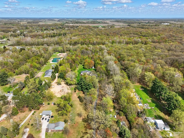 bird's eye view featuring a wooded view