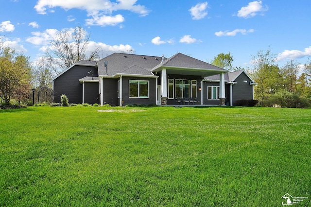 rear view of property with a yard