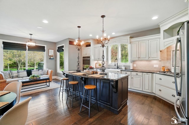 kitchen featuring appliances with stainless steel finishes, a kitchen breakfast bar, recessed lighting, and a wealth of natural light