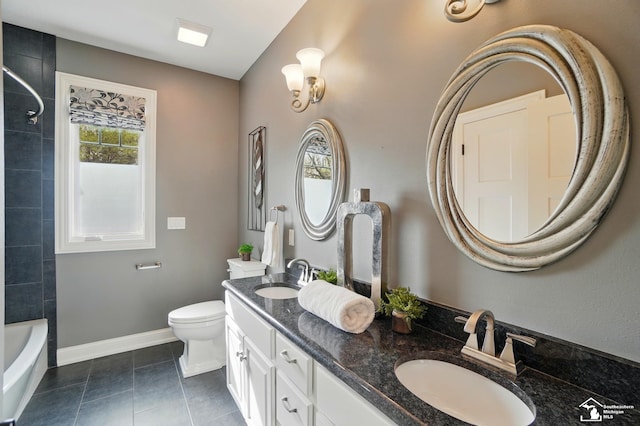 full bath with a sink, baseboards, toilet, and double vanity