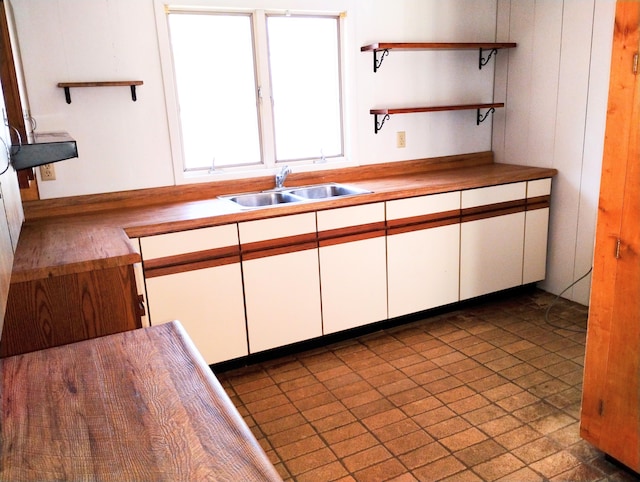 3100 Whipple Rd, Jackson, MI 49201 - kitchen featuring a sink, open shelves, and white cabinetry