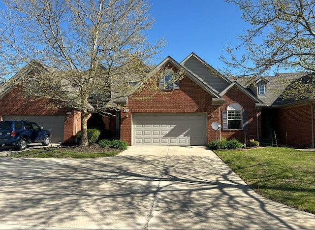 traditional-style home with concrete driveway, brick siding, and a front yard