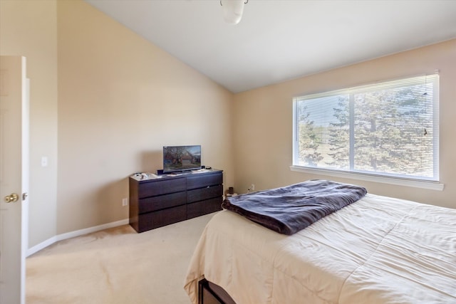 bedroom featuring carpet floors, baseboards, and vaulted ceiling