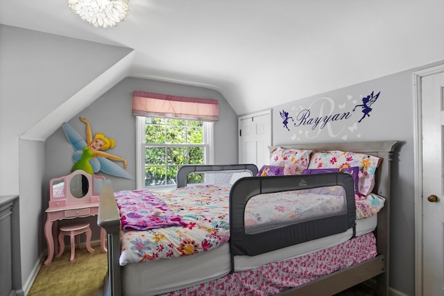 carpeted bedroom with lofted ceiling