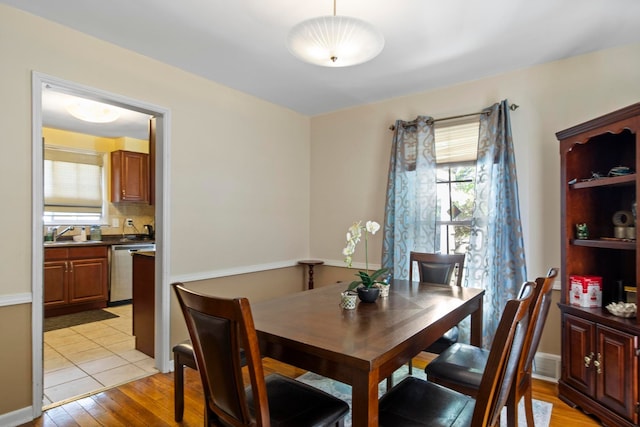 dining space featuring light wood-type flooring