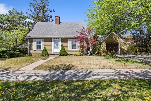 view of front of house featuring a garage, roof with shingles, a chimney, and a front lawn