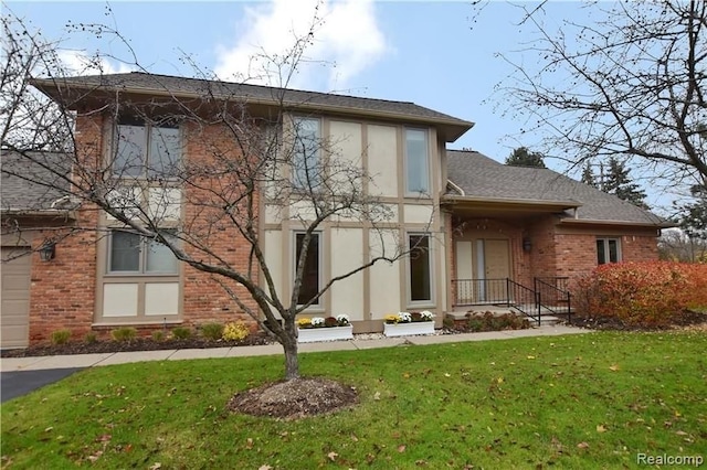 back of house with a lawn, stucco siding, and brick siding