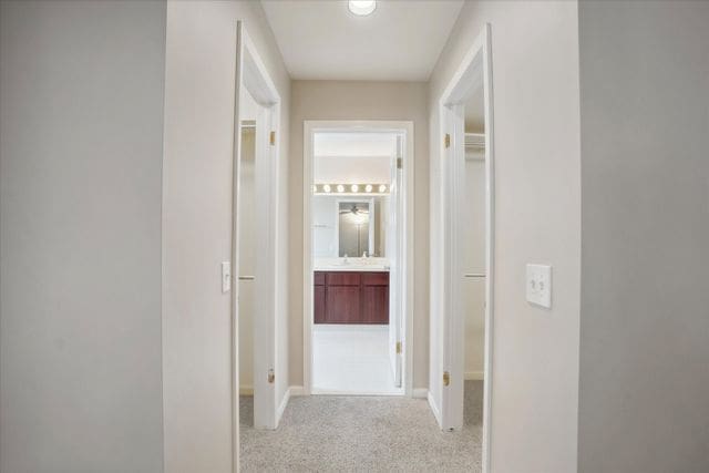hall featuring baseboards