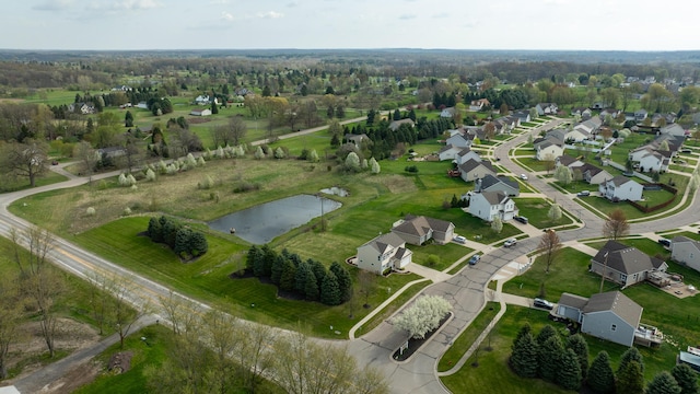 drone / aerial view featuring a water view and a residential view