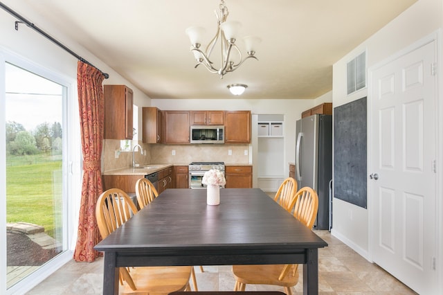 dining space featuring visible vents, light tile patterned floors, and a chandelier